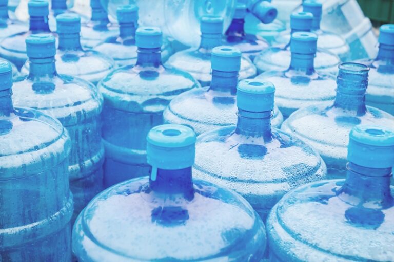 Big blue drinking water barrels, bottles, gallon, gets wet in th